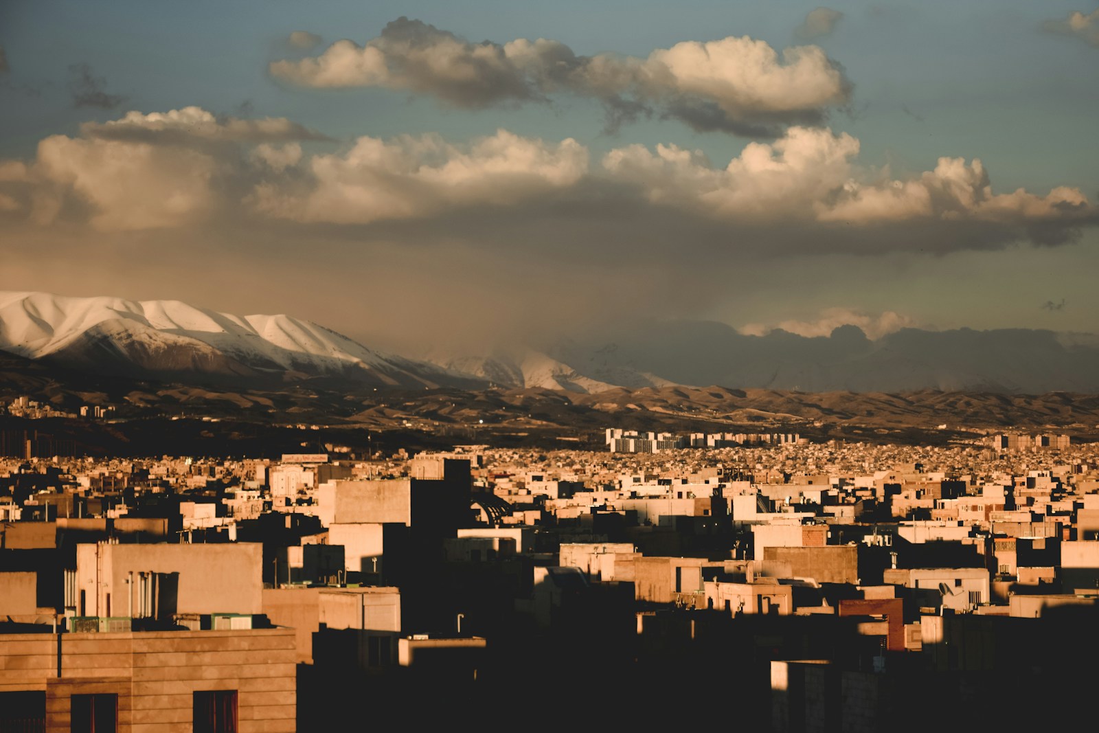 a view of a city with mountains in the background